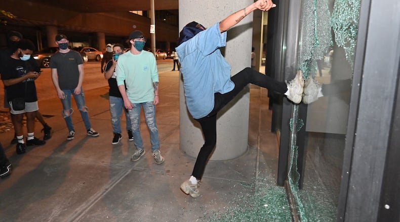 May 30, 2020 - Atlanta - Protesters attacking Police Zone 5 downtown. Small groups of people roam the streets after curfew Saturday, some vandalizing property, as protests began for a second day. Protests over the death of George Floyd in Minneapolis police custody spread around the United States on Saturday, as his case renewed anger about others involving African Americans, police and race relations.