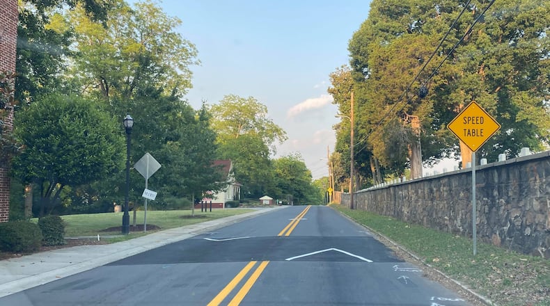 A speed table sign along Washington Avenue, a residential road near downtown Marietta. (Matt Bruce/For the AJC)