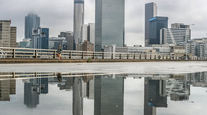 October 20, 2023 Atlanta: Neville Francis walks by the standing water along Martin Luther King Jr. Drive near Centennial Olympic Park Drive in downtown Atlanta on Friday, Oct. 20, 2023 as scattered showers and some isolated thunderstorms moved across metro. It’s much-needed moisture. “October is typically our driest month of the year. This year has held true to form,” Channel 2 Action News meteorologist Brian Monahan said. “We are about half an inch or so below average so far for the month of October, and for a month that’s already on the drier side, a little bit of rain helps. A cold front passed over the region, bringing in dryer air with it and setting us up for a “beautiful fall weekend,” Monahan said. On Saturday, temperatures will climb up to the mid 70s with mostly sunny skies. Similar conditions are in store for Sunday, though it might be just a touch cooler with a projected high back in the low 70s. The mild and sunny trend will stick around at least for the first half of next week. (John Spink / John.Spink@ajc.com)