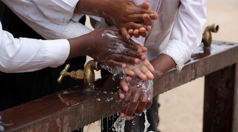 JOHANNESBURG, SOUTH AFRICA - OCTOBER 15: Children learn to wash their hands with Lifebuoy soap, at Margeret Gwele Primary School, Soweto,  on October 15, 2012 in Johannesburg, South Africa. Celebrated in over 100 countries, Global Handwashing Day is an annual awareness day which aims to put the global spotlight on handwashing with soap as a lifesaving habit. (Photo by Greg Marinovich/Getty Images for Unilever)