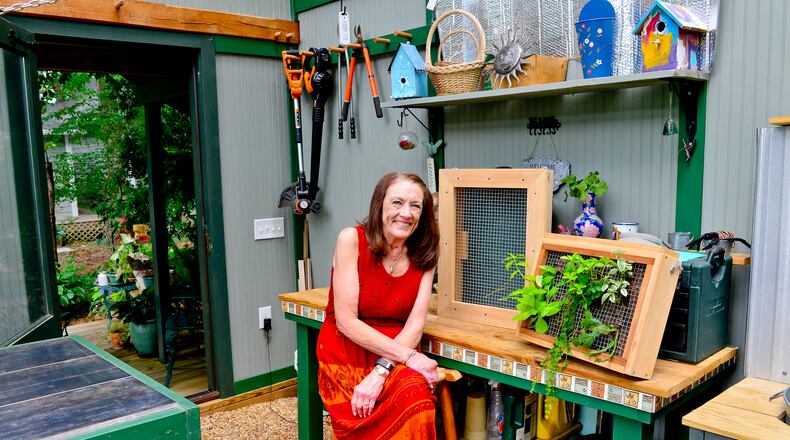 Teresa Stoker, who is retired, sits in her greenhouse/workhouse combination, where she grows a variety of plants from seeds to maturity and her husband does woodworking. Text by Lori Johnston and Shannon Adams/Fast Copy News Service.(Christopher Oquendo Photography/www.ophotography.com)