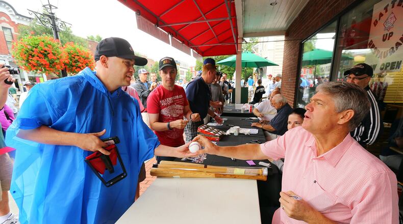 Former Braves center fielder and two-time NL MVP Dale Murphy signs an autograph for Philip Jones of Douglasville on Main Street in Cooperstown. (Curtis Compton/ccompton@ajc.com)