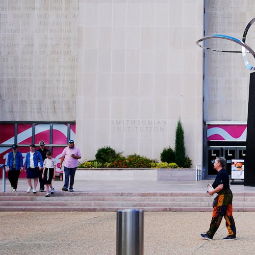 People walking past the "Infinity" sculpture outside the Smithsonian National Museum of American History on the National Mall in Washington, Tuesday, Sept. 8, 2026. (AP Photo/Pablo Martinez Monsivais)