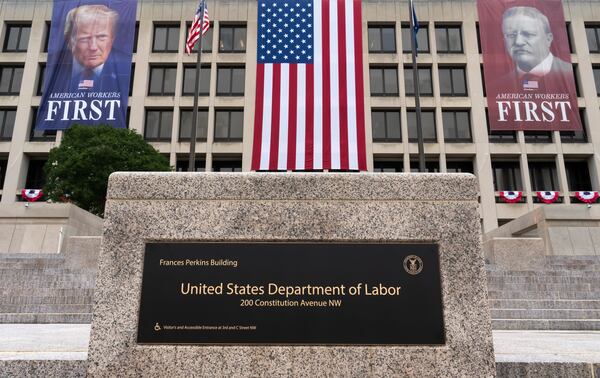 Portraits of Presidents Donald Trump and Theodore Roosevelt hang above the Department of Labor in Washington in July. (J. Scott Applewhite/AP).