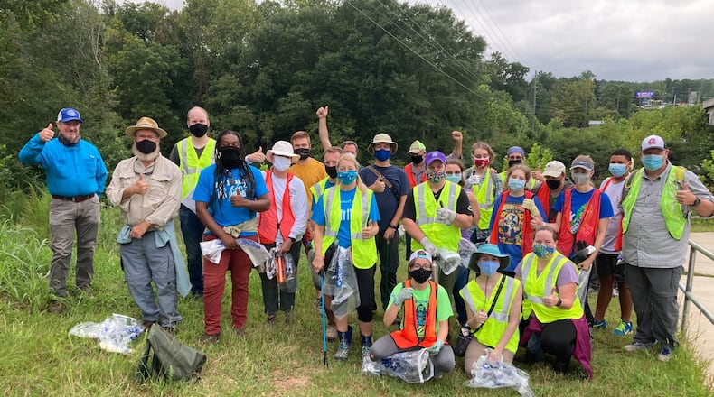 Danny Jackson, President of Trout Unlimited's Oconee River Chapter, Tixie Fowler with Georgia Association of Conservation Districts, Gwinnett Soil and Water Conservation District supervisors Louis Young and Ellis Lamme, Eagle Scout candidates with Boys Scouts of America were among the volunteers who met recently to help clean up Crayfish Creek in Sugar Hill.