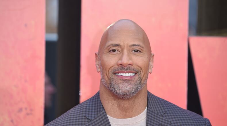 Actor Dwayne Johnson poses on the carpet arriving for the European premiere of the film Rampage in London on April 11, 2018. / AFP PHOTO / Anthony HARVEYANTHONY HARVEY/AFP/Getty Images