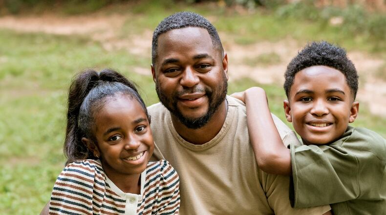 Mose James IV — with his daughter Jurnee and son Mose James V — said he and his dad had a business-style, handshake-heavy relationship. “I kiss and hug on my kids every single day,” he says. (Photo by Christy Gillam, Paperily Photography)