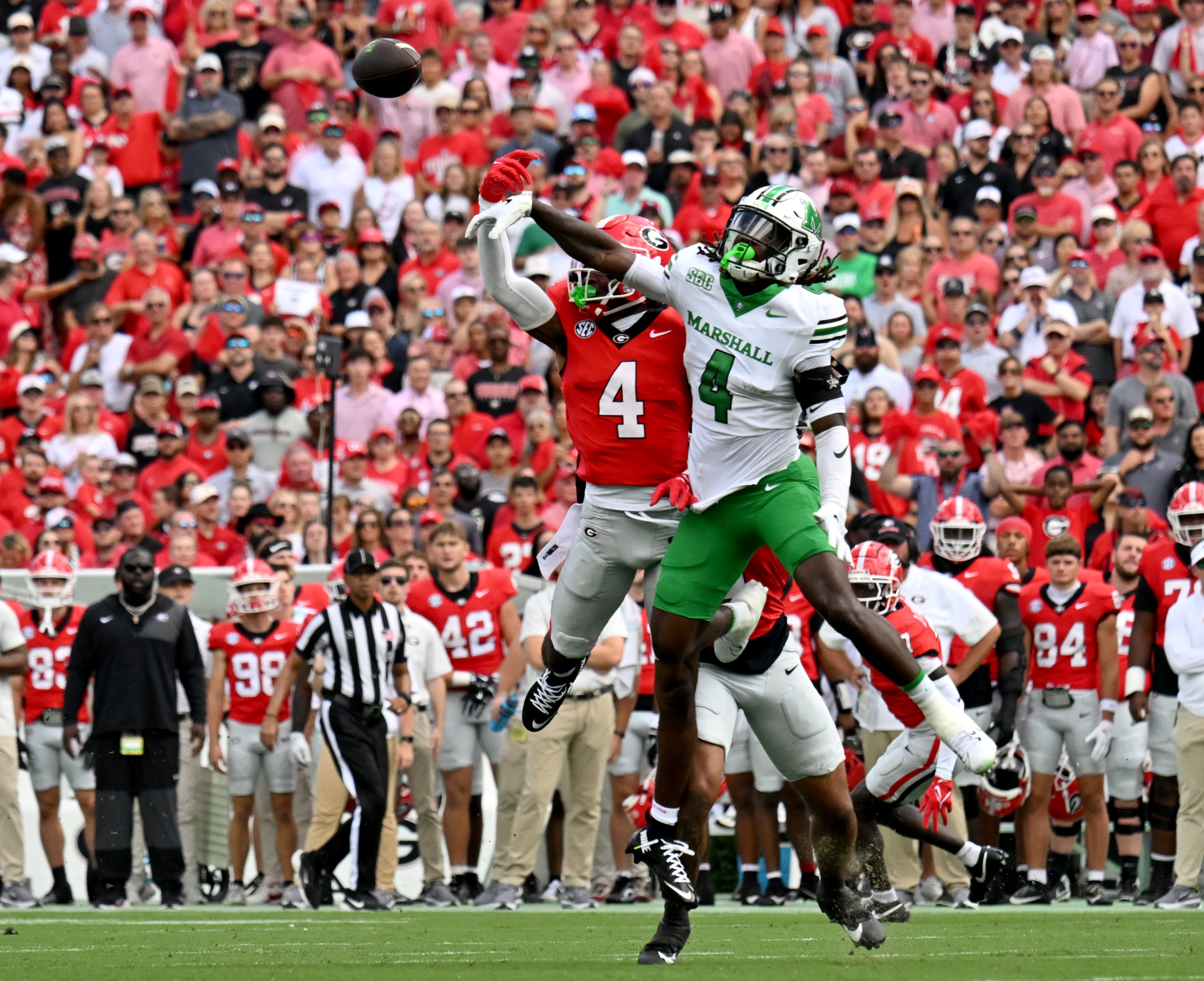 Georgia defensive back KJ Bolden (4) break up a pass intended for Marshall wide receiver Demarcus Lacey (4) during the first half in an NCAA football game at Sanford Stadium, Saturday, August 30, 2025, in Athens. (Hyosub Shin / AJC)