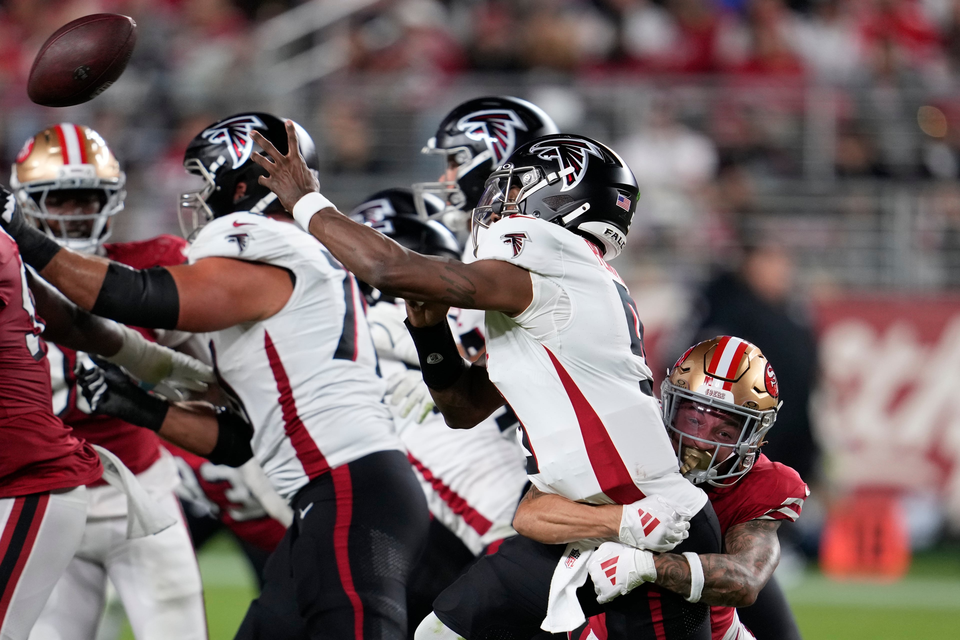 Atlanta Falcons quarterback Michael Penix Jr. (second from right) passes under pressure from San Francisco 49ers cornerback Chase Lucas (right) during the second half of an NFL football game on Sunday, Oct. 19, 2025, in Santa Clara, Calif. (Godofredo A. Vásquez/AP)