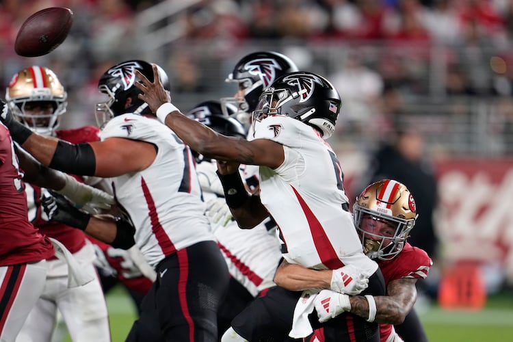 Atlanta Falcons quarterback Michael Penix Jr. (second from right) passes under pressure from San Francisco 49ers cornerback Chase Lucas (right) during the second half of an NFL football game on Sunday, Oct. 19, 2025, in Santa Clara, Calif. (Godofredo A. Vásquez/AP)