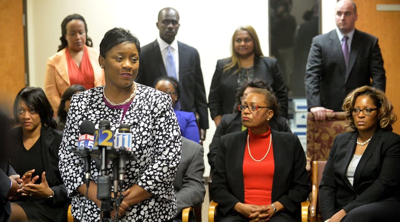 Tamara Cotman and several of the former Atlanta Public Schools educators, among them former APS Dobbs Elementary principal Dana Evans (from left, seated), former APS school reform team director Sharon Davis Williams and former APS Dobbs Elementary teacher Angela Williamson speak during a press conference at the law offices of defense attorney George Lawson on April 17, 2015. KENT D. JOHNSON /KDJOHNSON@AJC.COM