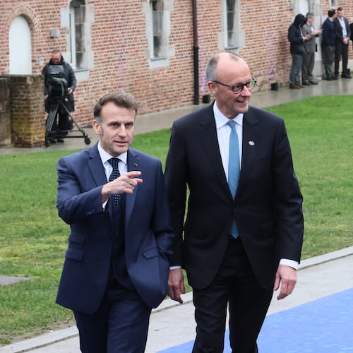 French President Emmanuel Macron, left, and Germany's Chancellor Friedrich Merz arrive for the EU summit at Alden Biesen Castle in Bilzen-Hoeselt, Belgium, Thursday, Feb. 12, 2026. (AP Photo/Francois Walschaerts)