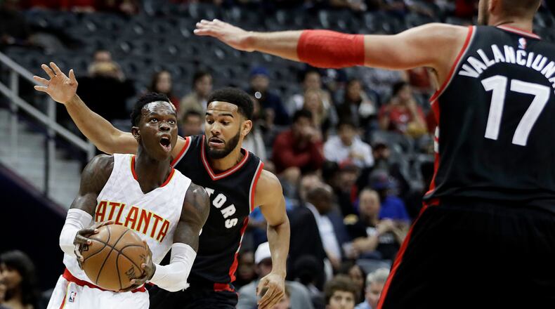 Atlanta Hawks’ Dennis Schroder drives to the hoop against the defense of Toronto Raptors’ Cory Joseph, rear, and Jonas Valanciunas, of Lithuania, in the first quarter of an NBA basketball game in Atlanta, Friday, March 10, 2017. Atlanta won 105-99. (AP Photo/David Goldman)