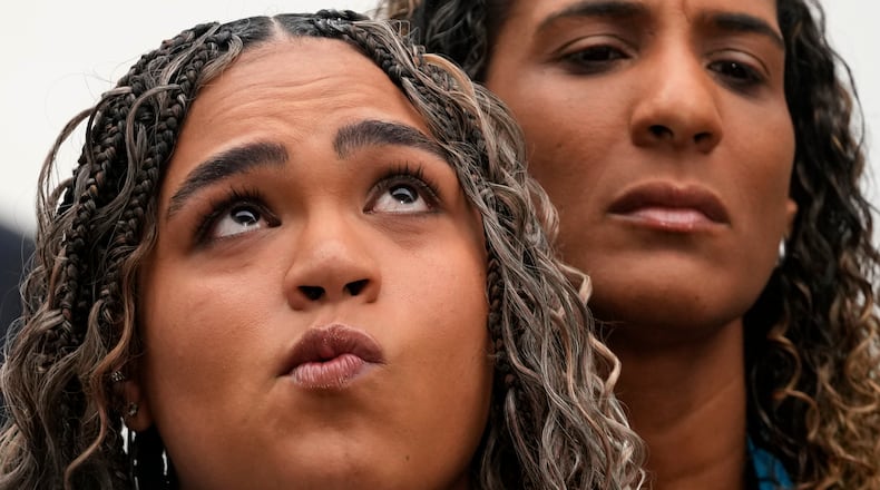 Luyara Franco, daughter of late councilwoman Marielle Franco, and her aunt Anielle Franco give a press conference at the Supreme Court before the start of the first day of trial of those accused of ordering Marielle's murder, in Brasilia, Brazil, Tuesday, Feb. 24, 2026. (AP Photo/Eraldo Peres)