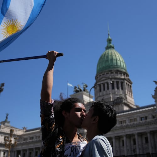 Cristian Valderrama kisses his husband Lucas Garcia during a protest outside Congress against a labor reform bill proposed by President Javier Milei's government in Buenos Aires, Argentina, Friday, Feb. 27, 2026. (AP Photo/Rodrigo Abd)