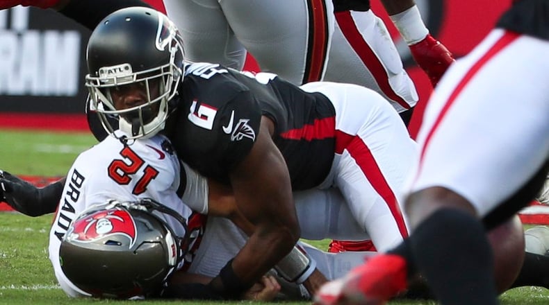 Tampa Bay Buccaneers quarterback Tom Brady (12) is sacked by Falcons defensive end Dante Fowler Jr. (6) as he fumbles the ball during the first half  Sunday, Sept. 19, 2021, at Raymond James Stadium in Tampa. (Dirk Shadd/Tampa Bay Times)