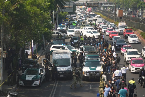 Police cordon off the area where Mexico City Mayor Clara Brugada's private secretary, Ximena Guzman, and adviser, Jose Munoz, were killed in Mexico City, Tuesday, May 20, 2025. (AP Photo/Fernando Llano)