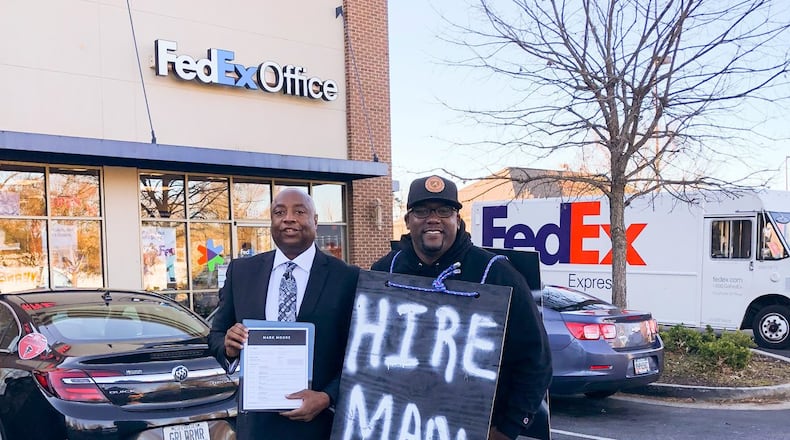 Mark Moore (left) and Terence Lester, founder of the nonprofit Love Beyond Walls, get ready to start the search for a job for Moore. Six days after launching #HireMark, Moore was offered a job. CONTRIBUTED