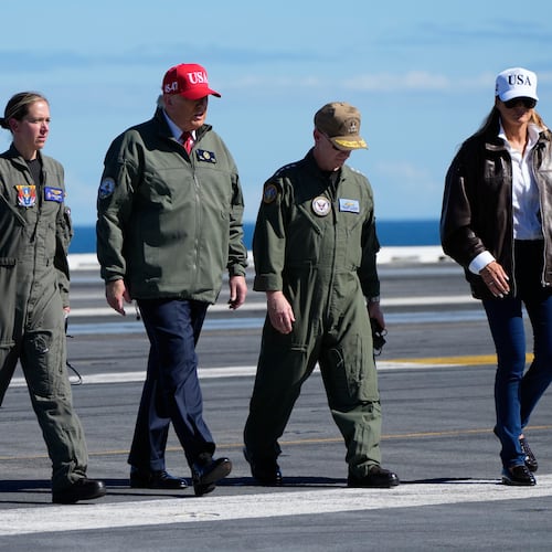 President Donald Trump and first lady Melania Trump walk on the flight deck as part of the Navy's 250th anniversary celebration, aboard the USS George H.W. Bush aircraft carrier in the Atlantic Ocean off the coast of Norfolk, Va., Sunday, Oct. 5, 2025. (AP Photo/Alex Brandon)