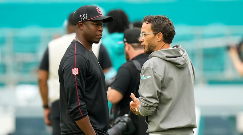 Atlanta Falcons head coach Raheem Morris, left, and Miami Dolphins head coach Mike McDaniel talks in the field before a pre season NFL football game, Friday, Aug. 9, 2024, in Miami Gardens, Fla. (AP Photo/Wilfredo Lee)