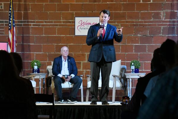 State Senator Burt Jones speaks as State Senator Brandon Beach looks during "2020 Election Integrity Townhall" meeting at The Lewis Loft in Rome on Tuesday, July 13, 2021. (Hyosub Shin / Hyosub.Shin@ajc.com)