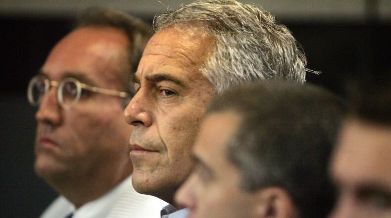 FILE - In this July 30, 2008, file photo, Jeffrey Epstein, center, appears in court in West Palm Beach, Fla. (Uma Sanghvi/The Palm Beach Post via AP, File)