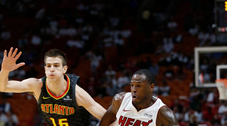 Miami Heat guard Dion Waiters (11) drives past Atlanta Hawks forward Nicolas Brussino (16) during the first half of an NBA preseason basketball game, Sunday, Oct. 1, 2017, in Miami.