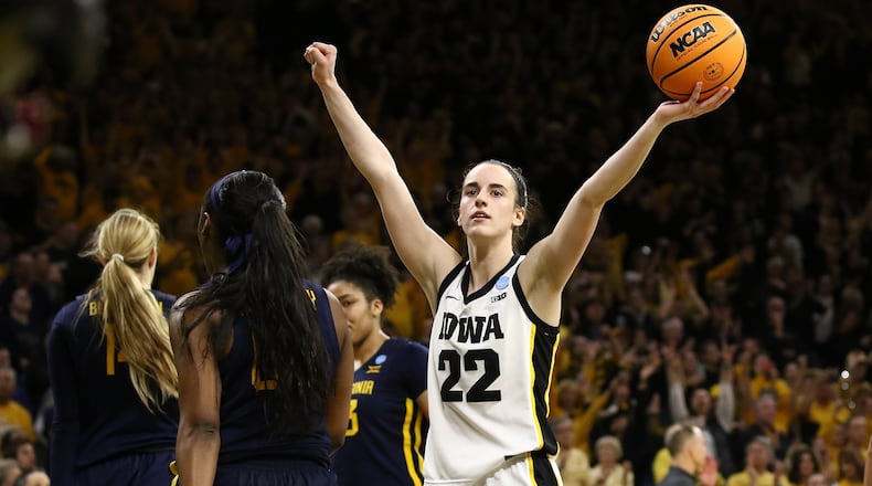 Guard Caitlin Clark of the Iowa Hawkeyes celebrates as time runs out in the second half against the West Virginia Mountaineers during their second round match-up in the 2024 NCAA Division 1 Women's Basketball Championship at Carver-Hawkeye Arena on March 25, 2024, in Iowa City, Iowa. (Matthew Holst/Getty Images/TNS)