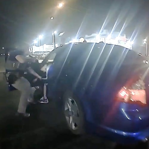In this image from video provided by the Texas Department of Public Safety, Homeland Security Investigations Special Agent Jack Stevens pulls Ruben Ray Martinez from his vehicle after shooting Martinez at a roadblock in South Padre Island, Texas, on March 15, 2025. (Officer Miguel Leal/Texas Department of Public Safety via AP)