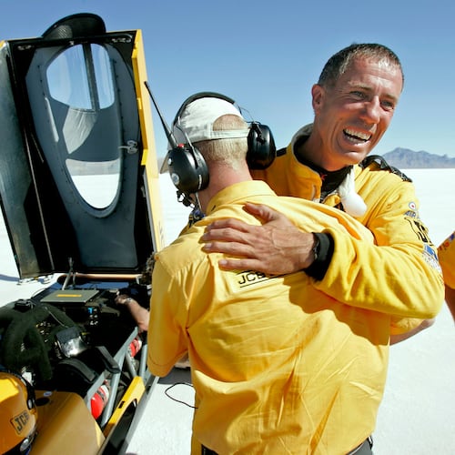 FILE - British driver Andy Green, right, is congratulated by a crew member after setting a new unofficial world diesel powered land speed record of over 328 mph over two runs on the Bonneville Salt Flats in Utah on Tuesday, Aug. 2006. (AP Photo/Douglas C. Pizac, File)