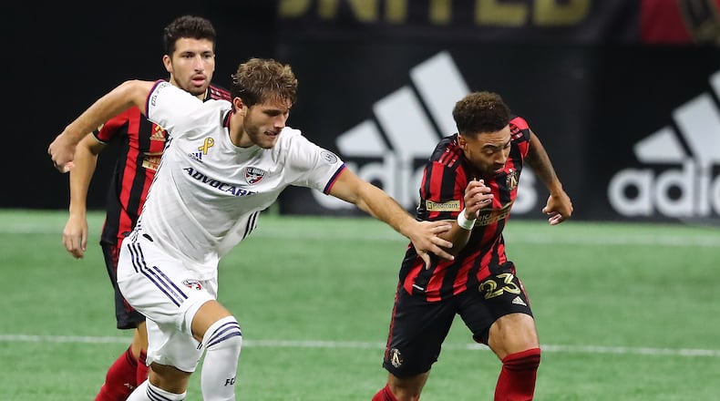 092320 Atlanta: Atlanta United midfielder Jake Mulraney steals from FC Dallas midfielder Francis Tessmann in a MLS soccer match on Wednesday, Sept. 23, 2020 in Atlanta.   “Curtis Compton / Curtis.Compton@ajc.com”