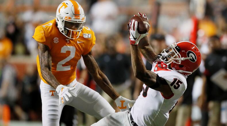 Georgia Bulldogs wide receiver Lawrence Cager (15) appeared to make a dramatic catch for a first down in the second quarter, defended by  Tennessee Volunteers defensive back Alontae Taylor (2), but on review it was ruled incomplete during todays UGA vs Tennessee NCAA football game at Neyland Stadium in Knoxville.  Bob Andres / robert.andres@ajc.com