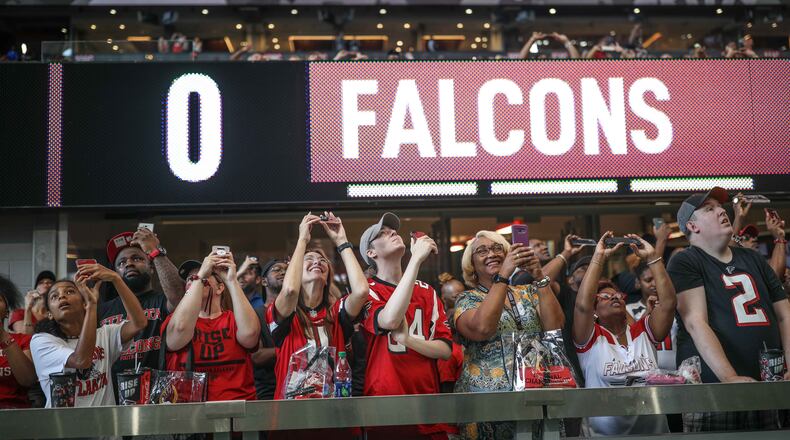 Fans look up as the roof opens during a ceremony before the Falcons open practice Sunday, July 29, 2018, at Mercedes-Benz Stadium in Atlanta.