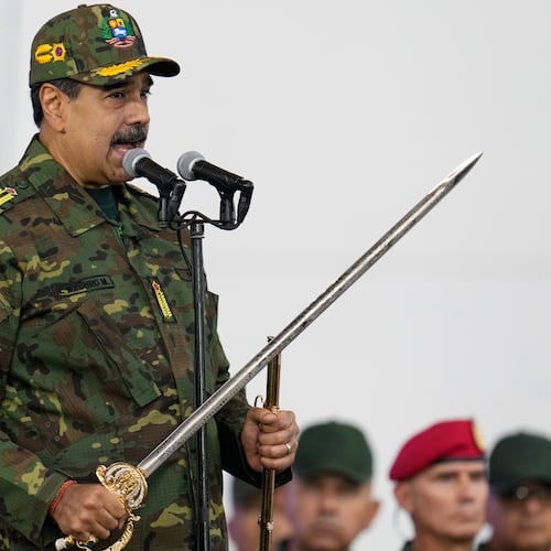 Venezuelan President Nicolas Maduro holds a ceremonial sword said to have belonged to independence hero Simon Bolivar during a government-organized civic-military march in Caracas, Venezuela, Tuesday, Nov. 25, 2025. (AP Photo/Ariana Cubillos)