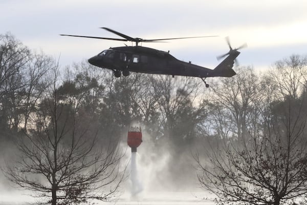 U.S. Army soldiers use Blackhawk helicopters to assist the South Carolina Forestry Commission and the South Carolina Department of Natural Resources with wildfire containment in Horry County, S.C., on Sunday. Elizabeth A. Schneider/U.S. Army via AP