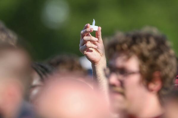 Electronic candles are lifted during a vigil on the Florida State campus at Langford Green, Tallahassee, Fla., Friday, April 18, 2025. (AP Photo/Gary McCullough)