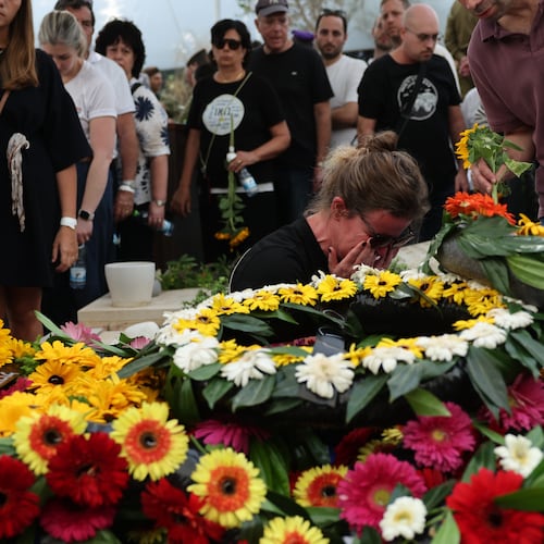 People mourn at the grave of Hadar Goldin an Israeli soldier killed in Gaza in 2014 and whose body had been held there until it was released Sunday, during his funeral in Kfar Saba, Israel, Tuesday, Nov. 11, 2025. (Abir Sultan/Pool via AP)