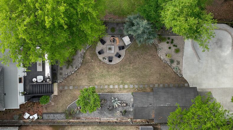 An aerial photo shows a concrete skate bowl (upper right) in the Atlanta backyard of Alison Michaels-Fandel and her husband, Derek Fandel, who enjoys skateboarding, Thursday, April 13, 2023. The Grant Park yard's transformation also includes a concrete fireplace with an adjacent sitting area (upper center). (Hyosub Shin / Hyosub.Shin@ajc.com)