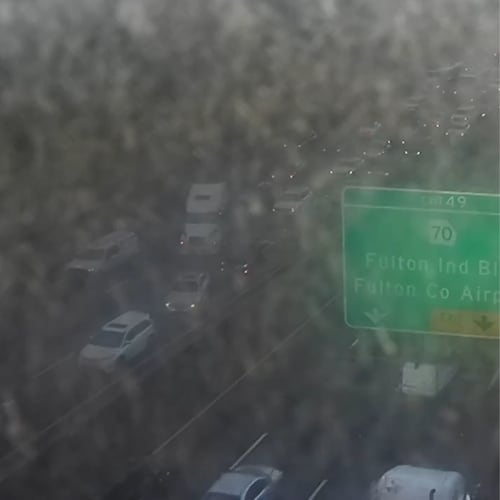 Morning sunshine reflects off a Georgia Department of Transportation traffic camera showing traffic delays caused by a crash on I-20 East just before I-285 in Fulton County on Tuesday, Nov. 11, 2025. (Georgia Department of Transportation)