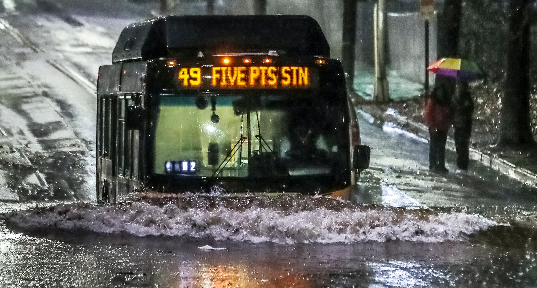 Near the former Turner Field, a MARTA bus trudged through standing water along Pollard Boulevard on Wednesday morning, January 4, 2023. Several routes were canceled or delayed due to flooding. The rain that moved in Tuesday evening brought with it flash flooding, severe thunderstorms and tornado watches across the state. (John Spink / John.Spink@ajc.com)

