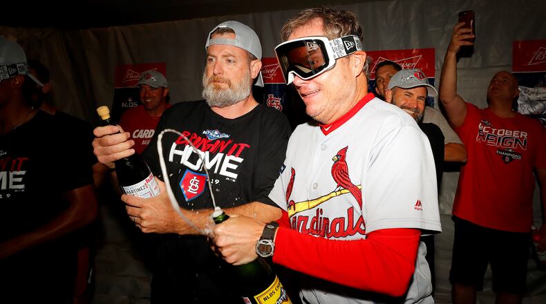 Manager Mike Shildt (right) of the St. Louis Cardinals celebrates in the locker room after his teams 13-1 win over the Atlanta Braves in game five of the National League Division Series at SunTrust Park on October 09, 2019 in Atlanta, Georgia. (Photo by Kevin C. Cox/Getty Images)