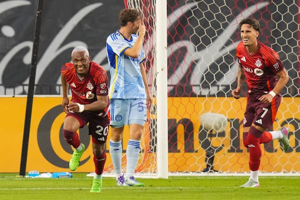 Toronto FC midfielder Deybi Flores (20) celebrates after scoring as Atlanta United's Aleksey Miranchuk (59) and Toronto FC's Theo Corbeanu (7) look on during second-half MLS soccer match action in Toronto, Saturday, July 12, 2025. (Chris Young/The Canadian Press via AP)