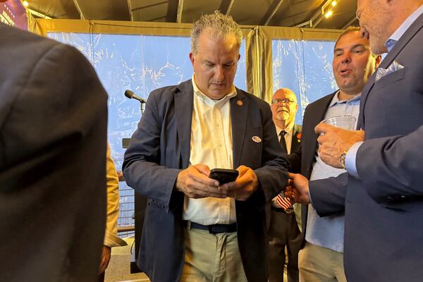 Republican Jimmy Patronis looks at his phone during an election watch party while awaiting election results Tuesday, April 1, 2025, in Pensacola, Fla. (AP Photo/Kate Payne)