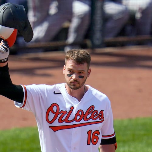 FILE - Baltimore Orioles' Trey Mancini tips his helmet as fans give him a standing ovation prior to a baseball game against the Boston Red Sox, April 8, 2021, on Opening Day in Baltimore. (AP Photo/Julio Cortez, File)