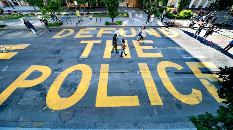 The words "Defund the Police" were added by protesters alongside the words "Black Lives Matter" near the White House in Washington.