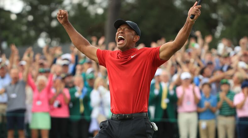 Tiger Woods (L) of the United States celebrates on the 18th green after winning the Masters at Augusta National Golf Club on April 14, 2019 in Augusta, Georgia. Woods is scheduled to be honored at the White House on Monday for his victory.