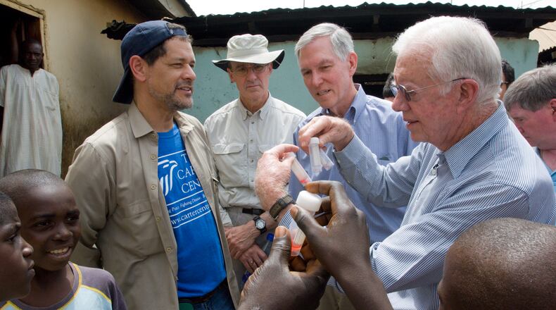 Dr. Frank Richards (in hat) with former President Jimmy Carter (right) in Africa. Richards is helping guide The Carter Center’s fight against river blindness, made possible by the work of two researchers who won the Nobel Prize for Medicine. The Carter Center/L. Gubb