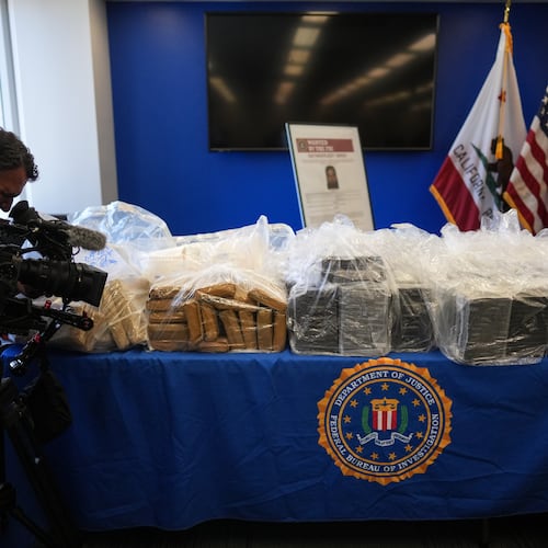 A cameraman records seized evidence at a news conference at the Federal Building in Los Angeles, Tuesday, July 7, 2026. (AP Photo/Jae C. Hong)