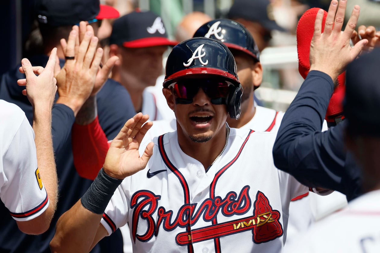 Atlanta Braves' Mauricio Dubón shakes hands with teammates after scoring during the fourth inning against the Athletics at Truist Park on Wednesday, April 1, 2026, in Atlanta. (Miguel Martinez/AJC)