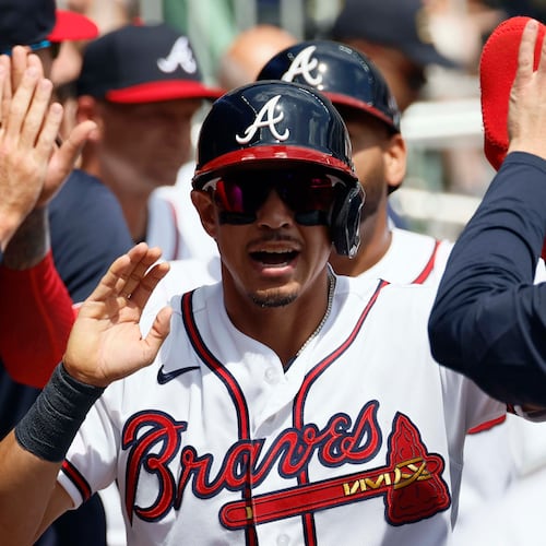 Atlanta Braves' Mauricio Dubón shakes hands with teammates after scoring during the fourth inning against the Athletics at Truist Park on Wednesday, April 1, 2026, in Atlanta. (Miguel Martinez/AJC)